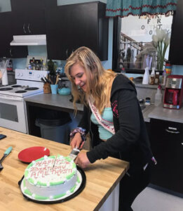 Amethyst, Youth House Grad, cutting cake