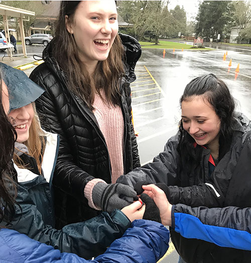 A group handshake sets a tone of unity and cooperation for Marist students.