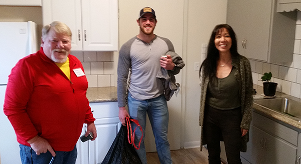 Cpl. Stenson admires his new kitchen with contractor Jeremy Dibos and Brenda Wilson of the Lane Council of Governments.