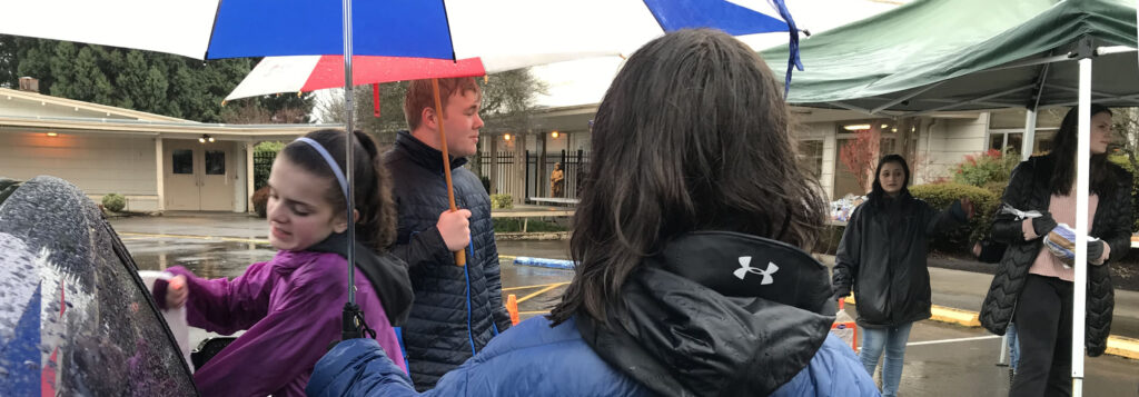 At St. Paul Church, students from Marist High School served up the goods from a breezeway of umbrellas.