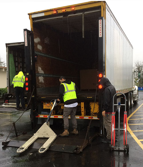 St. Vinnie's trucking staff prepares to unload the components of hundreds of Holiday Food Boxes. It's a busy time for drivers and helpers alike.